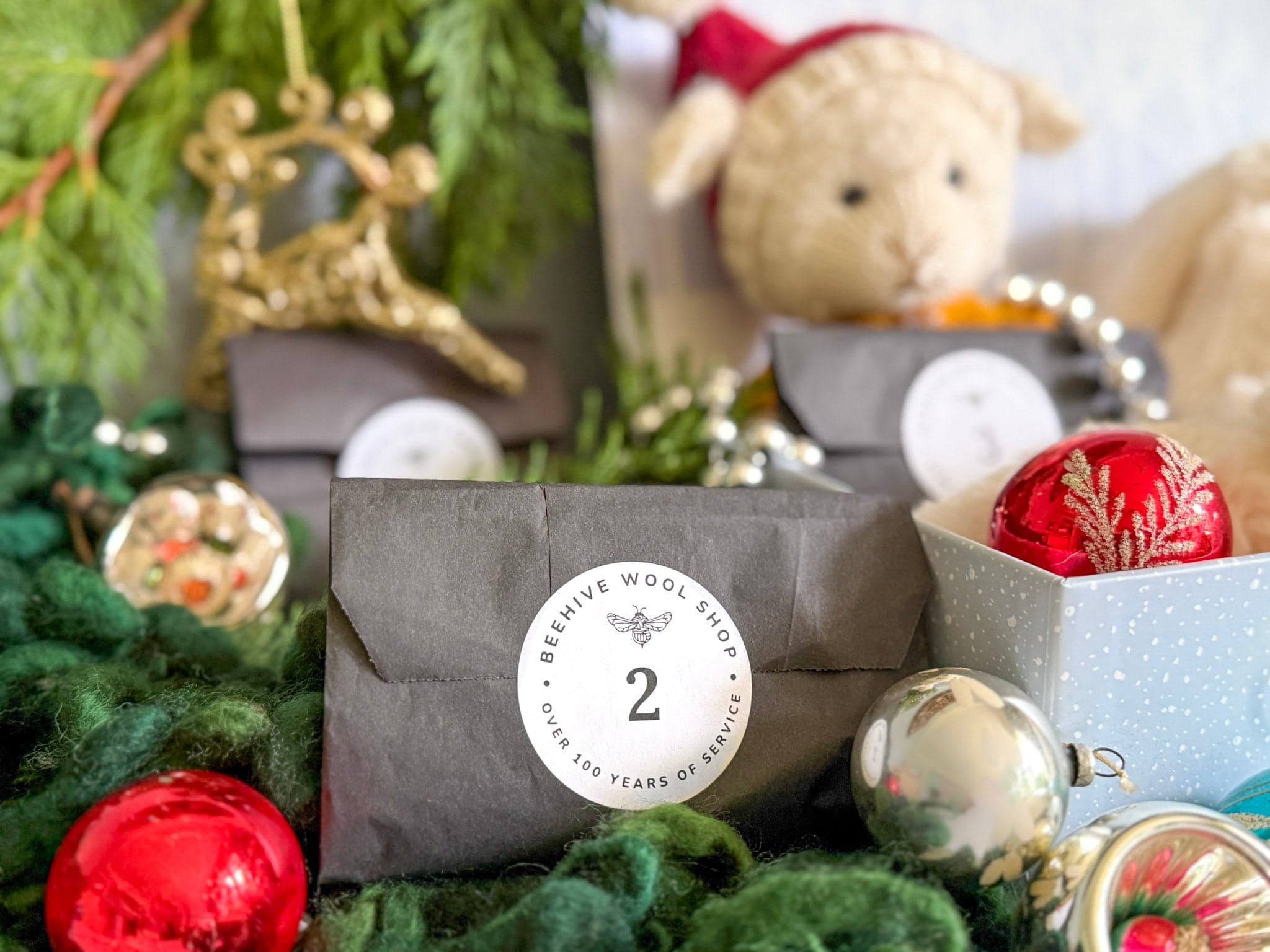 Beehive Wool Shop’s advent calendar gifts with numbered parcels and Christmas decorations